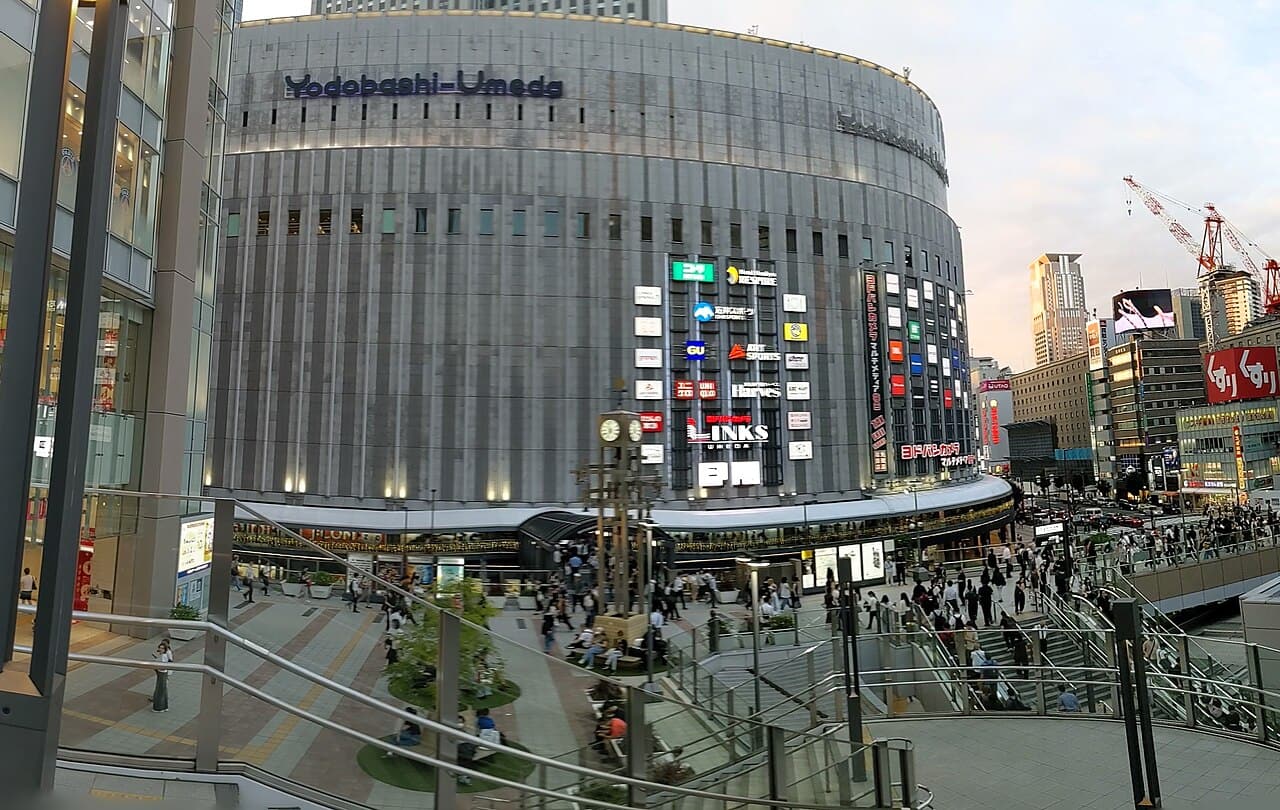 The curved Yodobashi-Umeda building and crowds outside Osaka Station