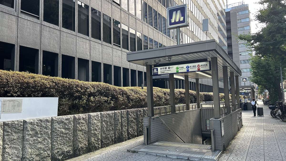 大阪メトロ本町站 13 號出入口:人行道旁往地下的樓梯口,招牌寫著本町駅(船場西)13 出入口,並列中央線、四つ橋線、御堂筋線三條線的標誌,上方立著 Osaka Metro 的 M 字標