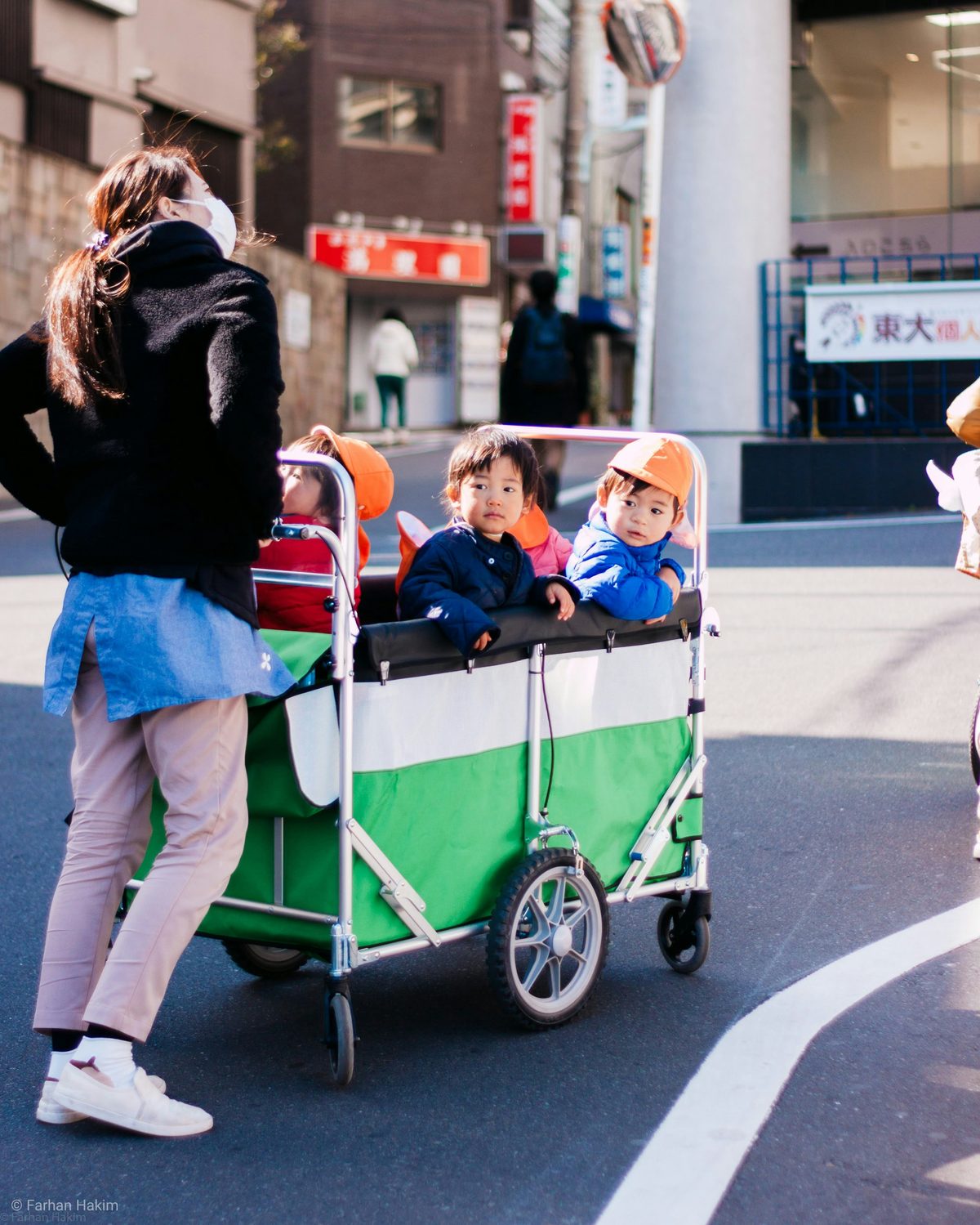 Family navigating a Tokyo train station with a stroller: elevator access and barrier-free pathways