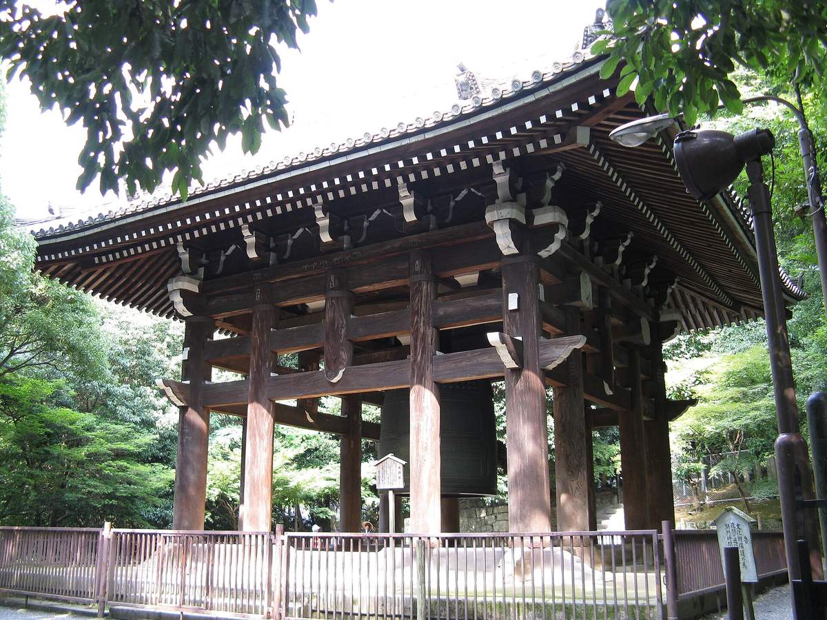 The wooden bell tower at Chion-in with its enormous bronze bell hanging inside, ringed by a low wooden fence