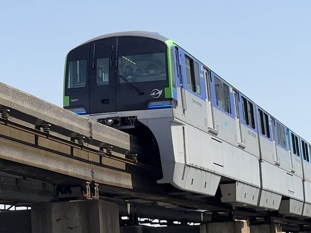 Tokyo Monorail elevated track snaking past Tokyo Bay with Odaiba in the background