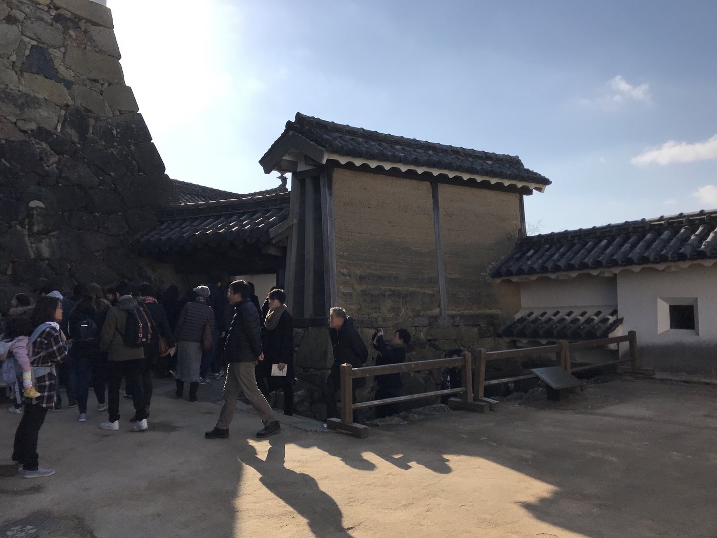 The narrow Mizu-no-ichimon gate and white plaster walls on the climbing route at Himeji Castle