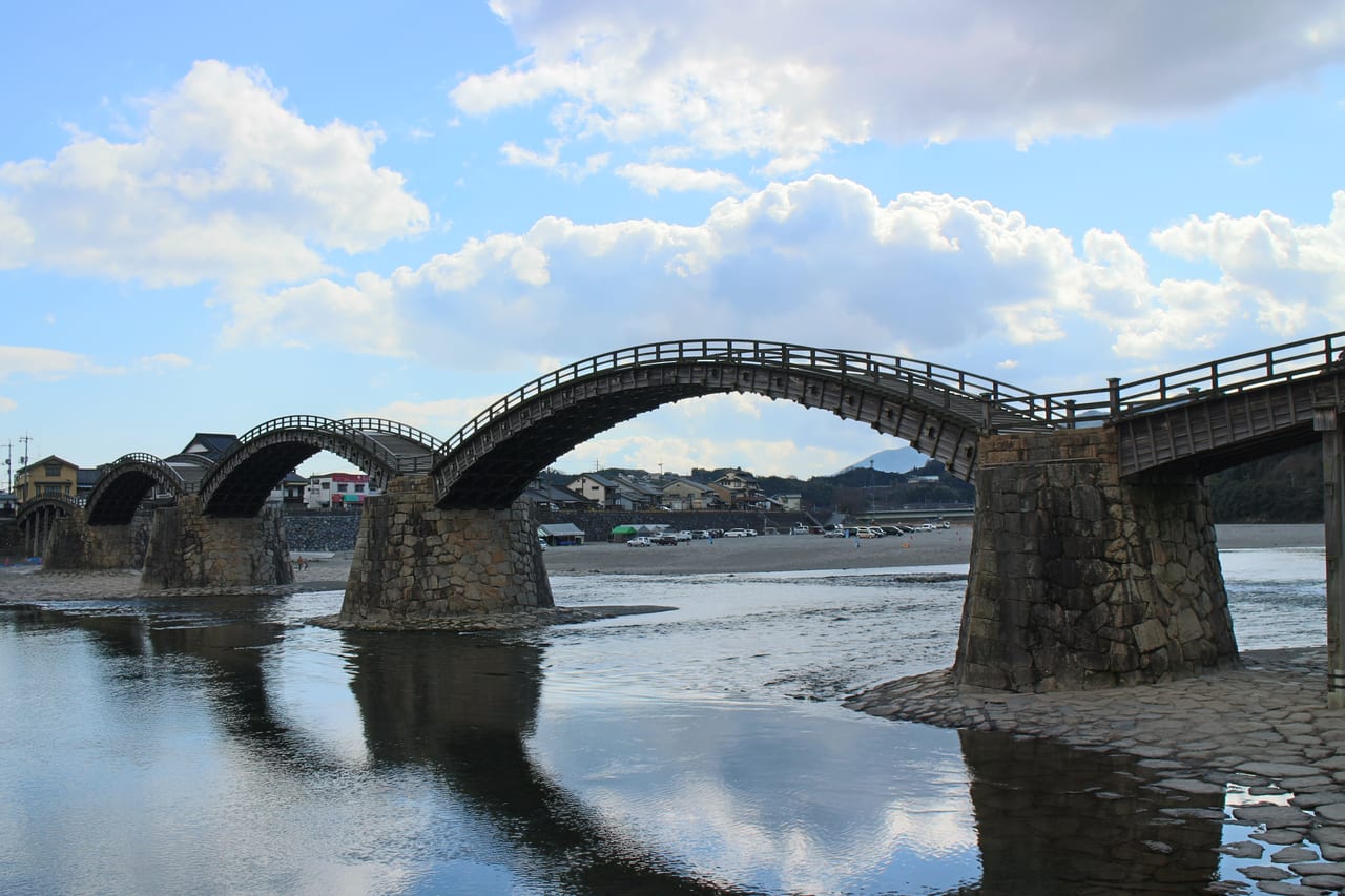 A wide view of Kintaikyo Bridge's five wooden arches over the Nishiki River