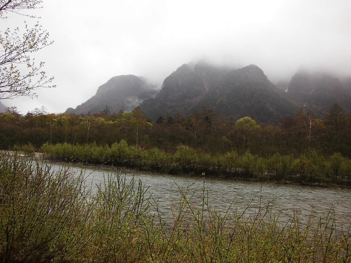 The clear Azusa River in Kamikochi with forested banks