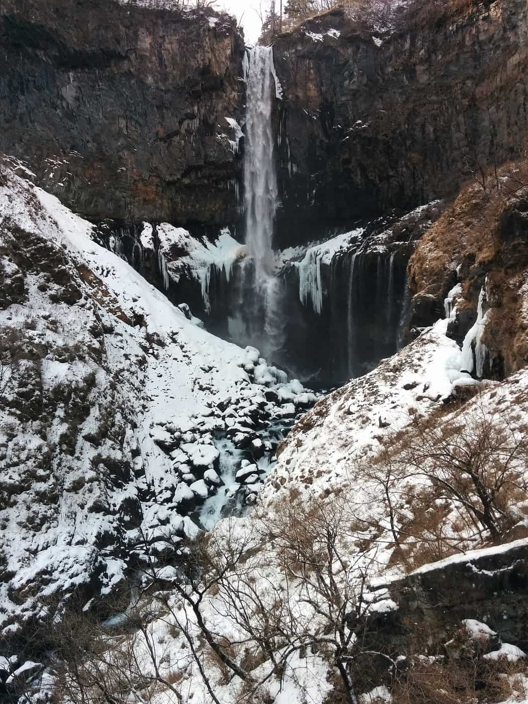 Kegon Falls in winter with the main plunge still flowing while the surrounding Junitaki cascades hang frozen in columns of ice