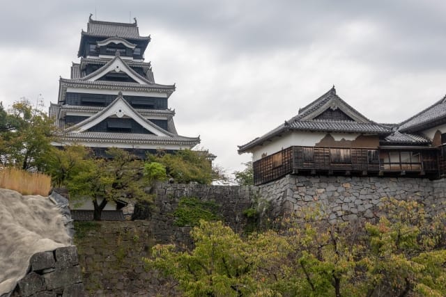 Kumamoto Castle: black wooden keep above stone walls