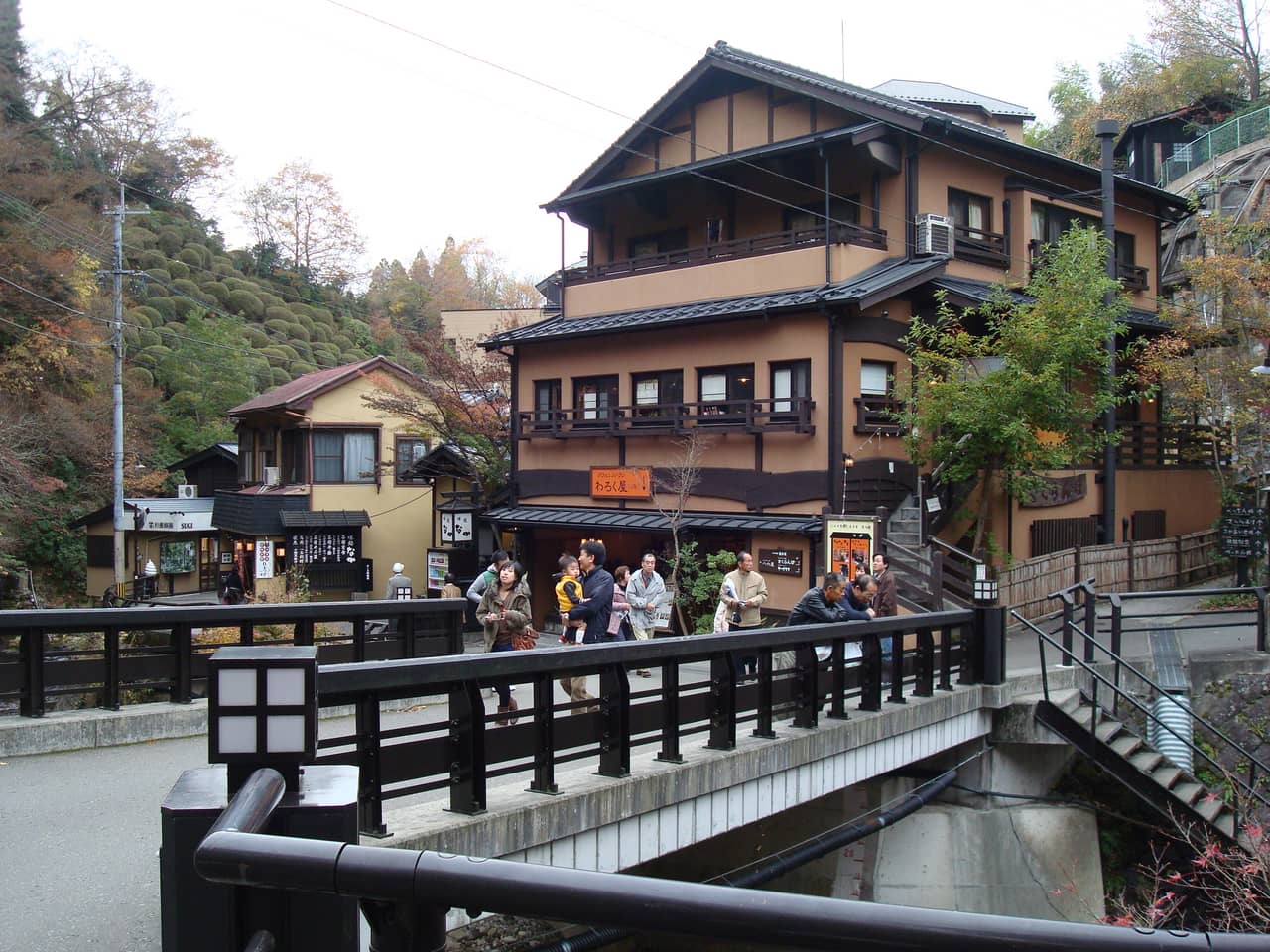 Wooden ryokan and stone steps lining a street in Kurokawa Onsen