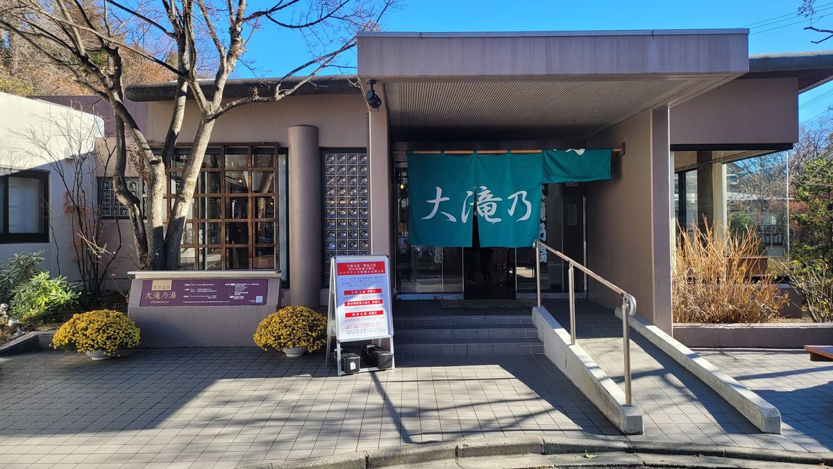 大滝乃湯入口,綠色暖簾寫著「大滝乃」,門前立牌是三個町營浴場的維修休館通知