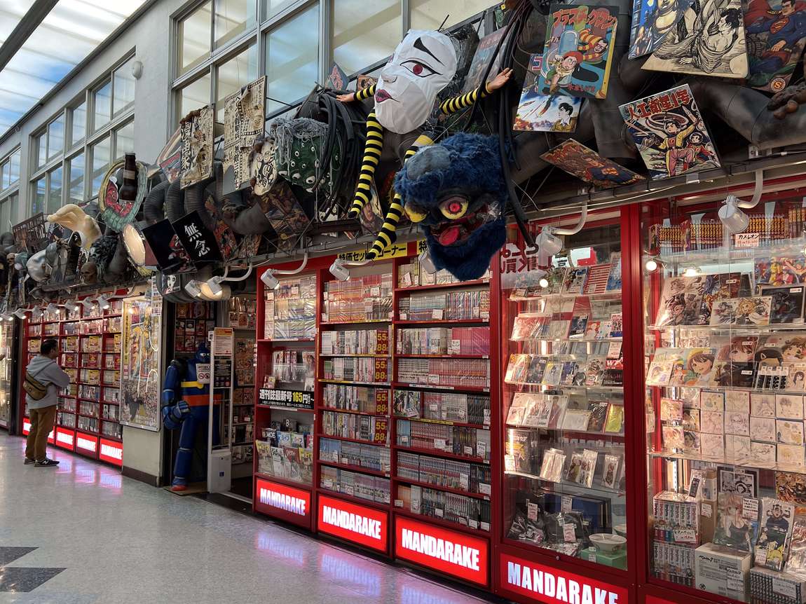 The red-fronted Mandarake main store on the third floor of Nakano Broadway, display cases running the length of the corridor