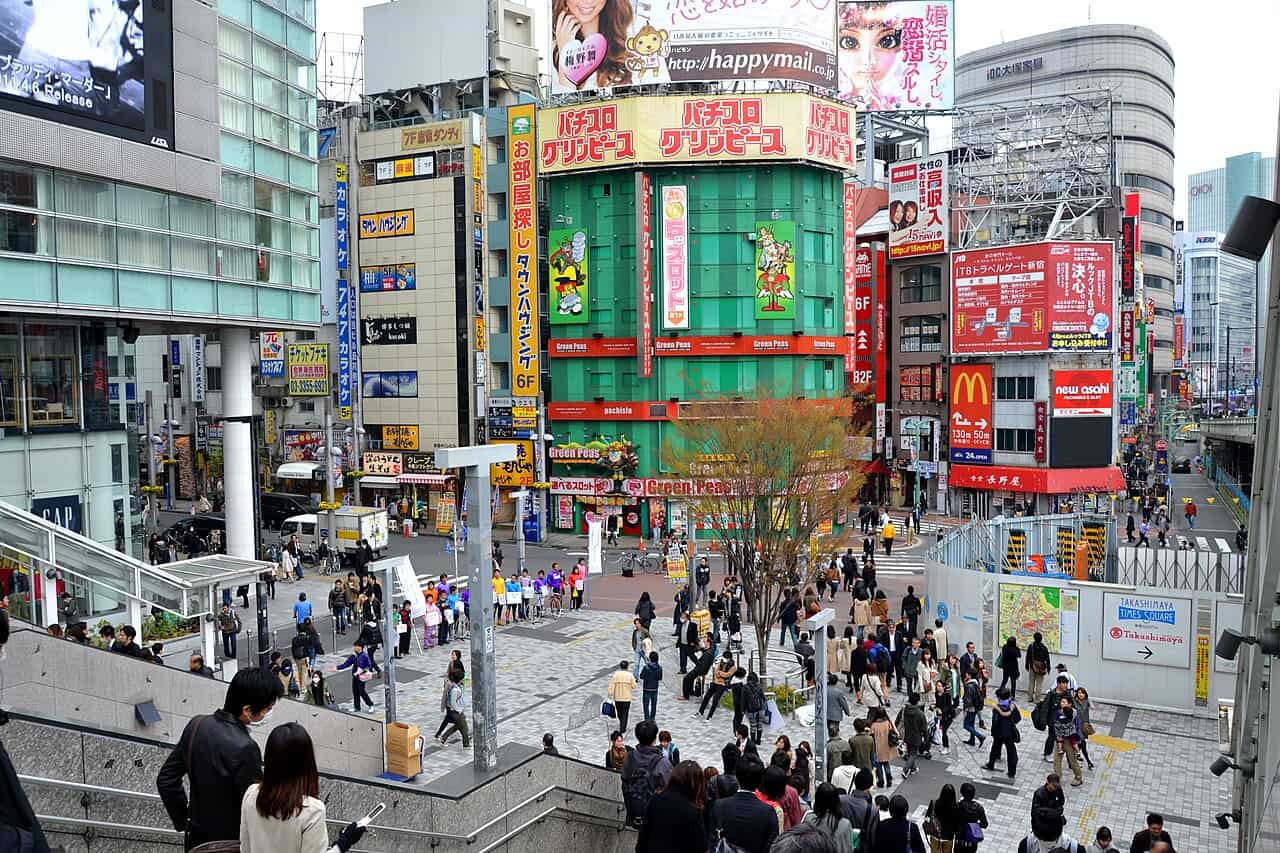 Dense crowds outside Shinjuku Station's southeast exit — first-timers routinely underestimate the daily fatigue of constant moving and crowds