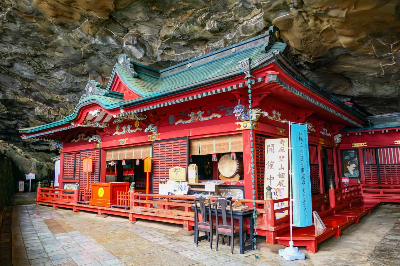 The vermilion main hall of Udo Jingu set inside a sea cave in the Nichinan Coast cliff