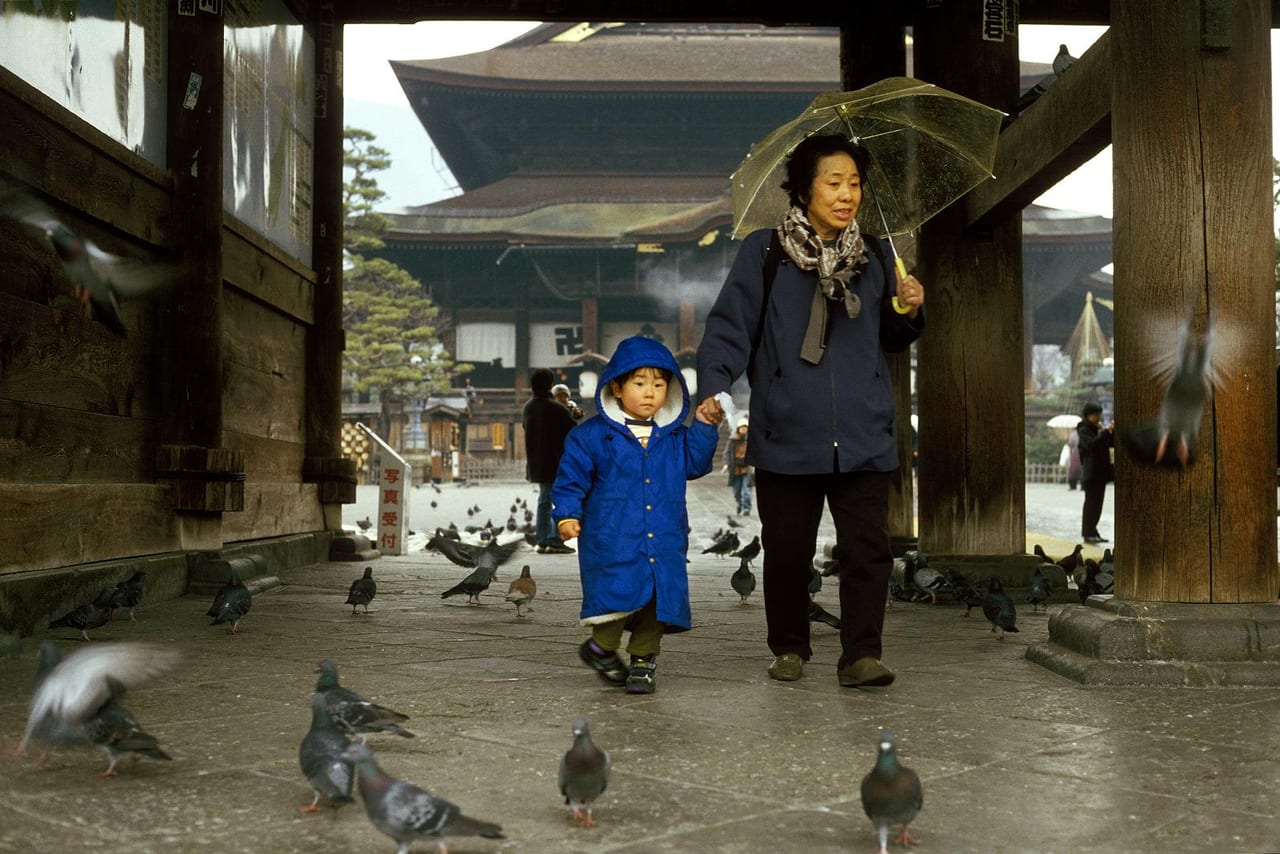 The massive Sanmon gate and stone-paved approach at Zenkoji temple