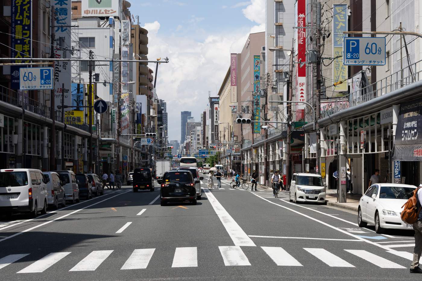 The main Sakaisuji street through Den-Den Town in Nipponbashi, Osaka, shop signage receding into the distance