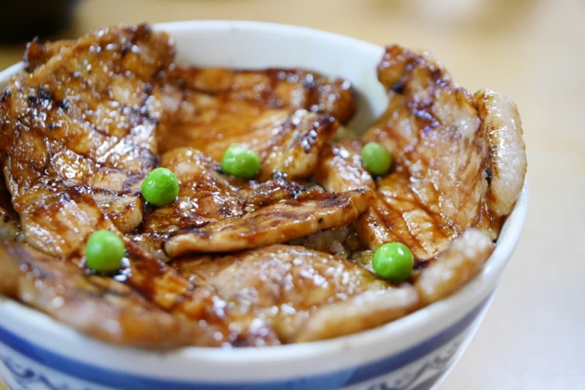 Obihiro butadon: charcoal-grilled pork slices over white rice with sweet-savoury glaze