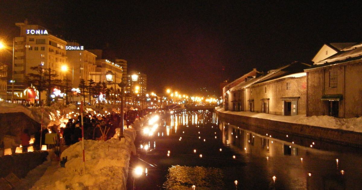 Candles and floating lanterns lit along the Otaru Canal at night during the Snow Light Path festival