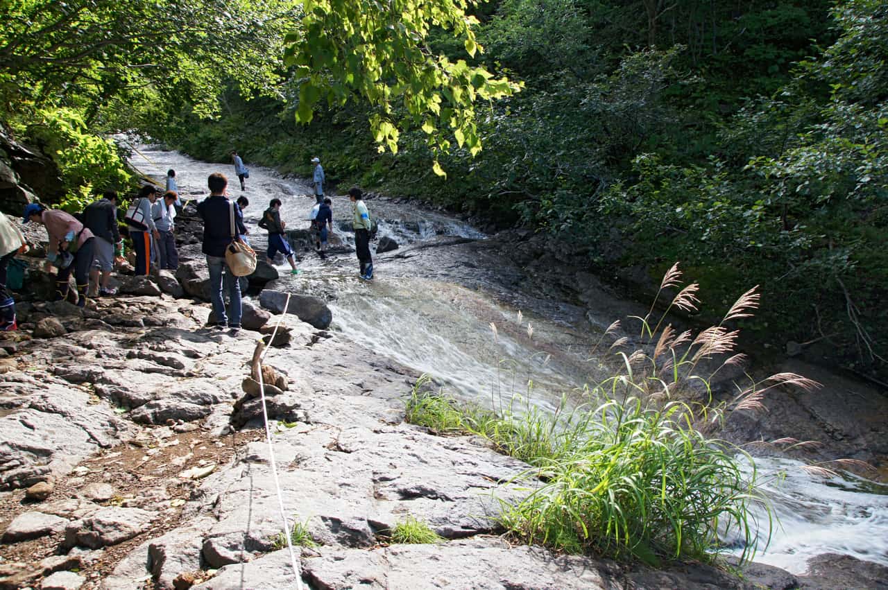 The Kamuiwakka hot waterfall in Shiretoko, onsen water running down a rock bed