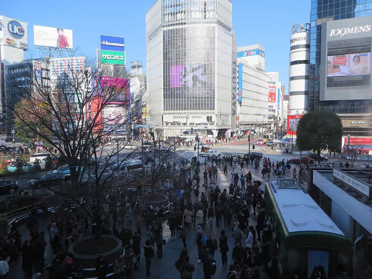 A lone traveler standing amid the crowds at Shibuya Crossing in Tokyo — a sign that Japan is one of the best places to travel solo