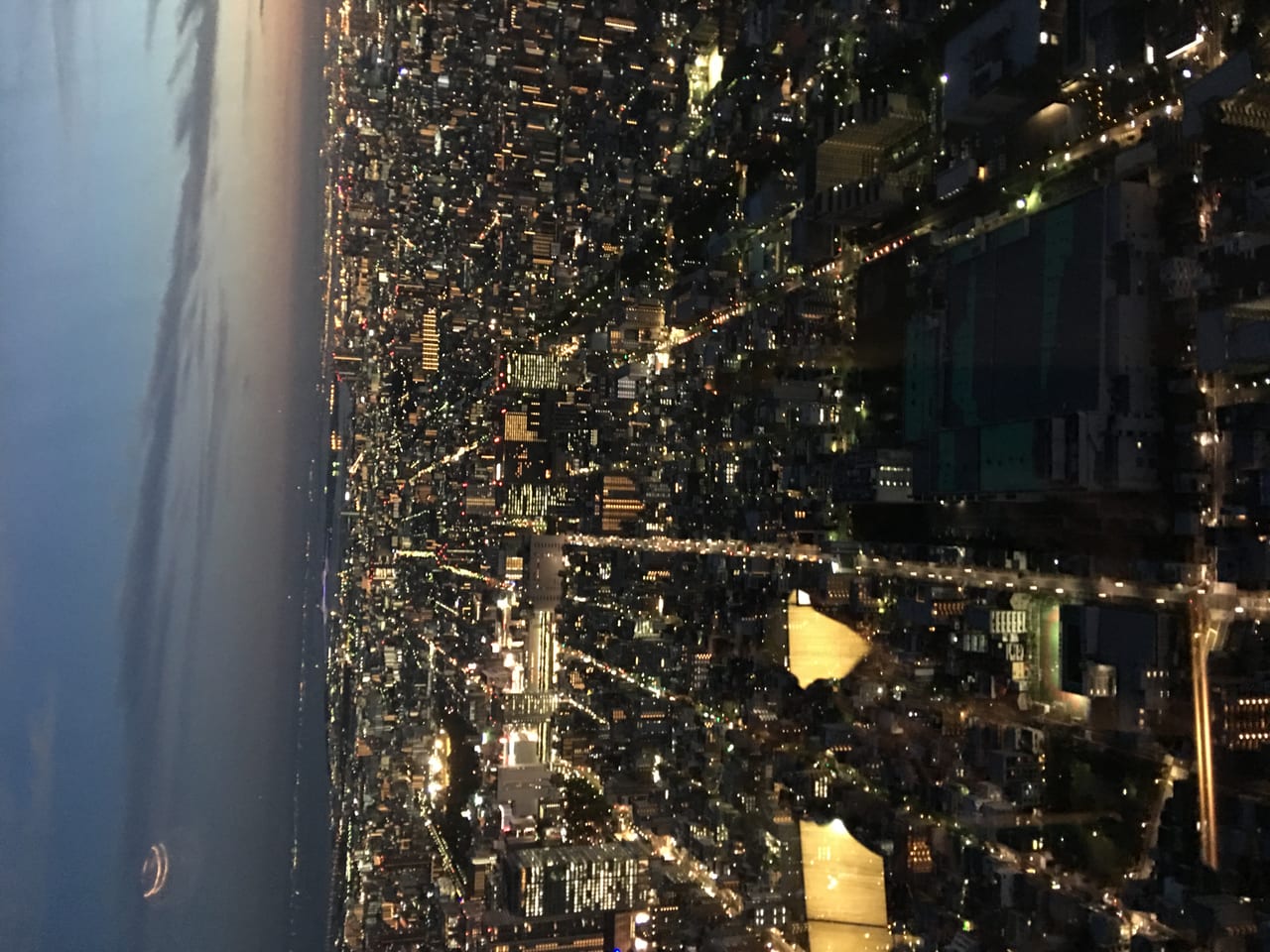 The sea of city lights of Tokyo at night seen from a Skytree observation deck