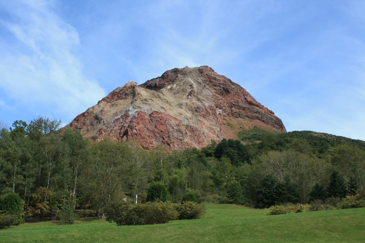 The reddish, still-smoking dome of Showa Shinzan, a young volcano that rose from a wheat field in 1943
