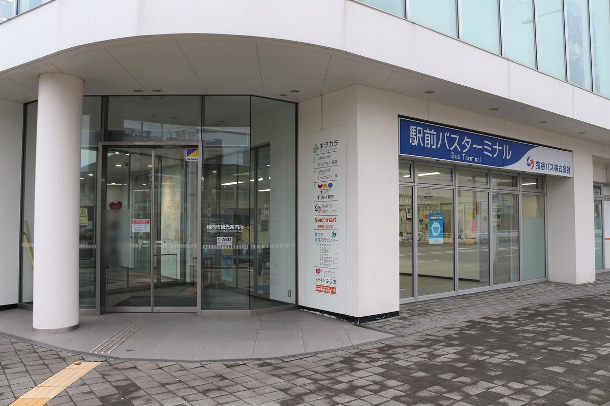 稚內站站前大樓「キタカラ」1 樓轉角,左邊是稚內市觀光案內所的玻璃門,右邊藍色招牌寫著「駅前バスターミナル Bus Terminal 宗谷バス株式会社」,中間立牌列出大樓內的設施