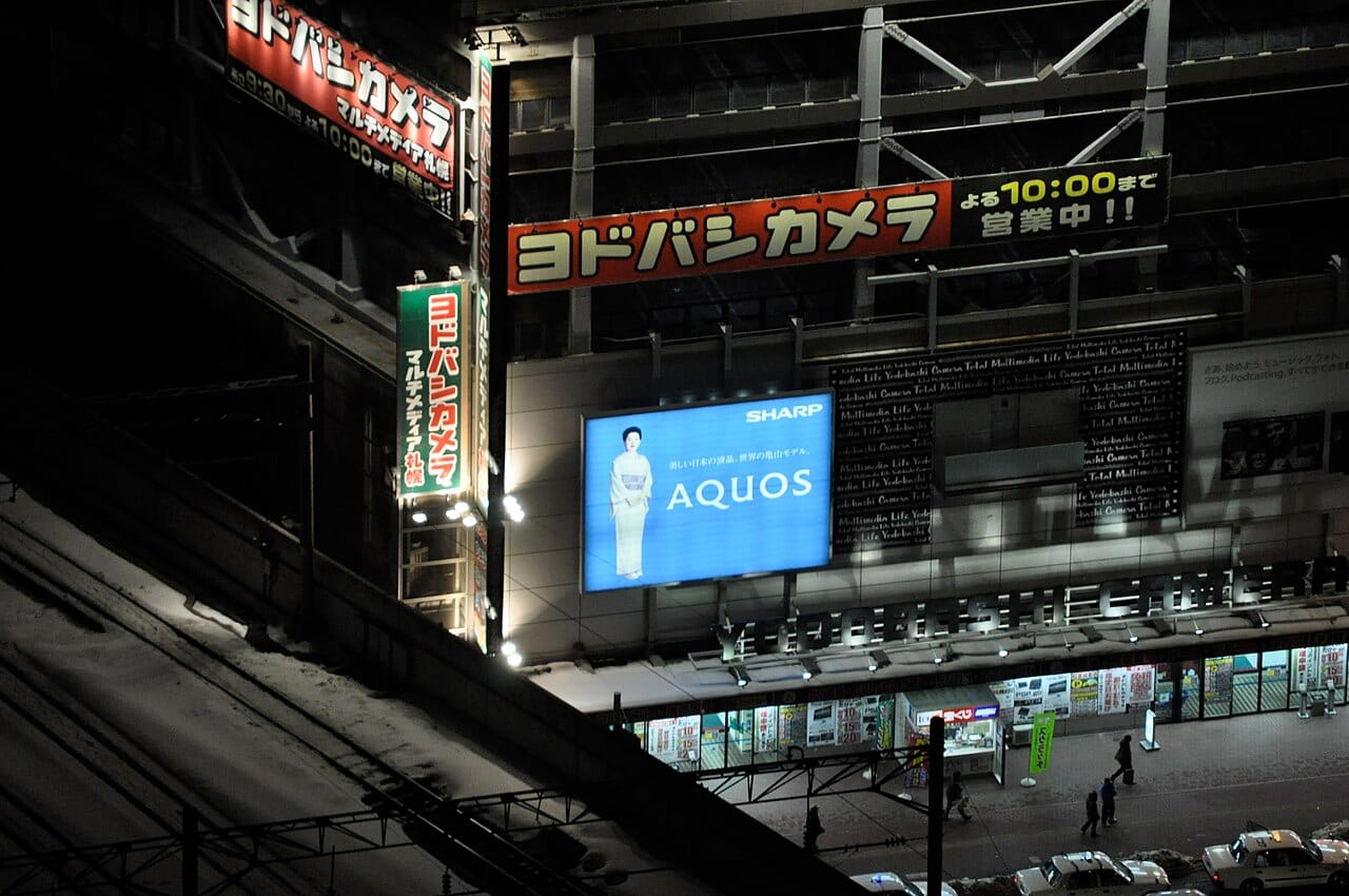 Illuminated Yodobashi signage in Sapporo at night showing opening hours until 10pm