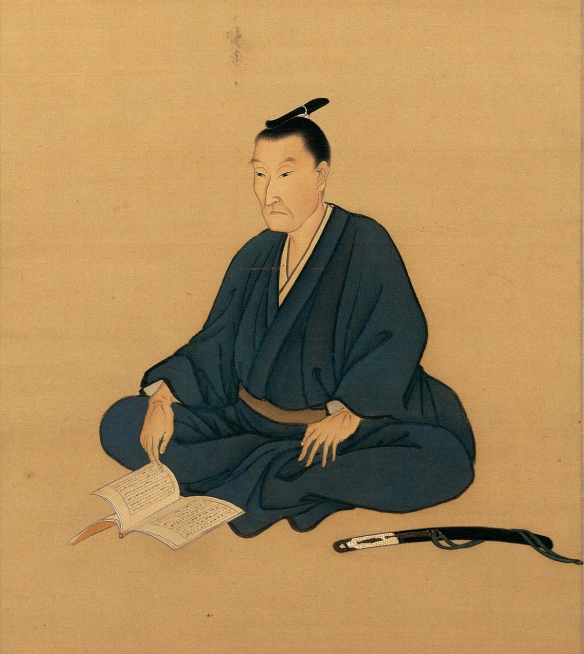 Silk portrait painting of Yoshida Shoin seated cross-legged with an open book and a sword at his side