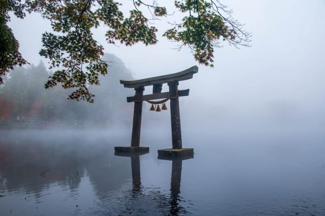 Yufuin Kinrin Lake: morning steam mist rising over the water with Mount Yufu in the background