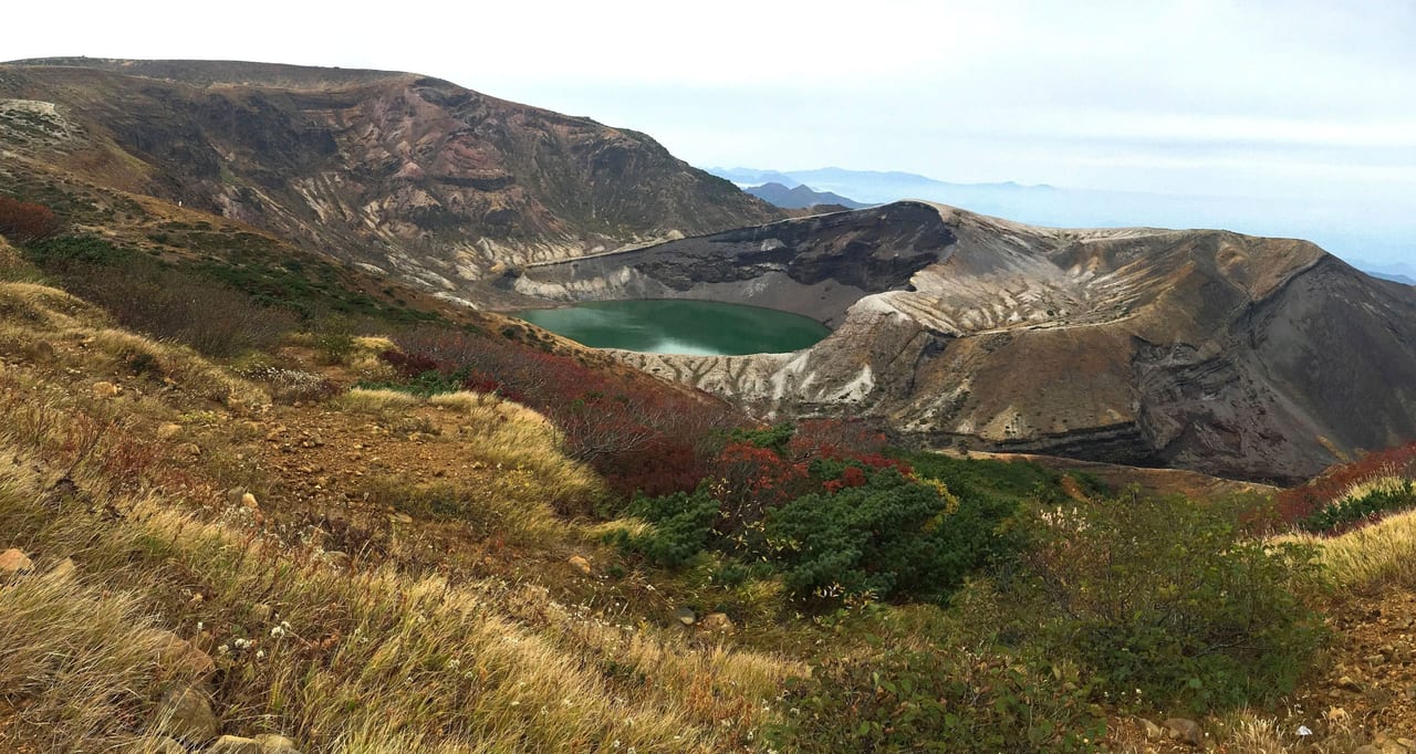 The emerald-green Okama crater lake at Zao, visible only when the Zao Echo Line road is open in summer and autumn