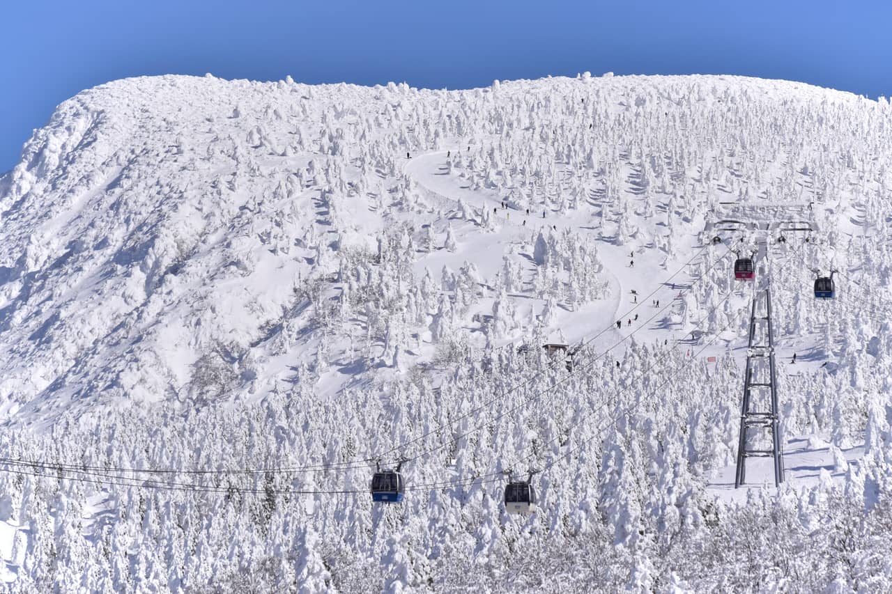 Snow scenery around Zao Onsen Ski Resort, with ski runs and ropeway cables visible in the distance